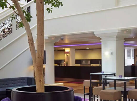 lobby inside Thwaites with a tree and sitting area