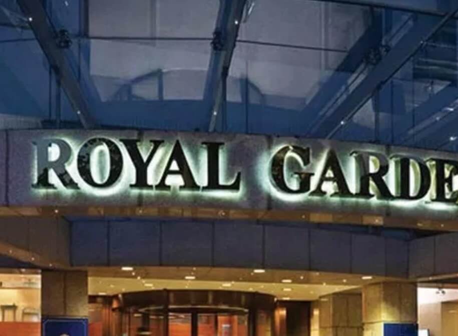 the royal garden sign lit up during the night