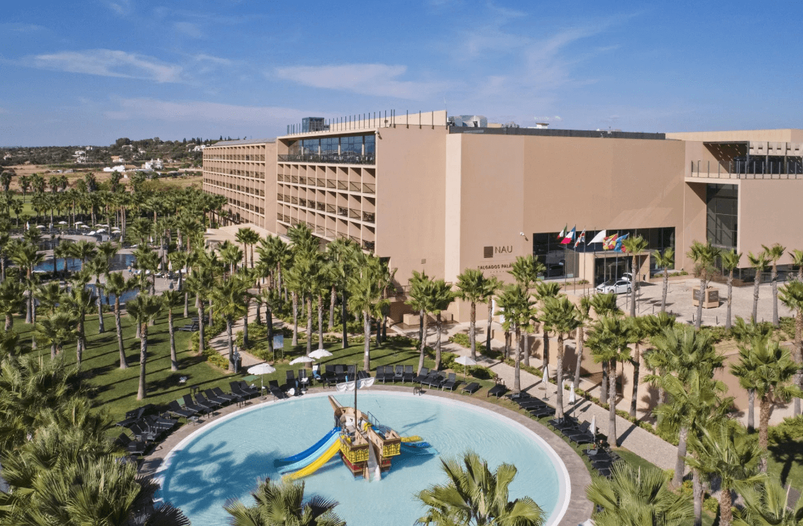 aerial view of the NAU surrounded by palm trees and a circular water park out front