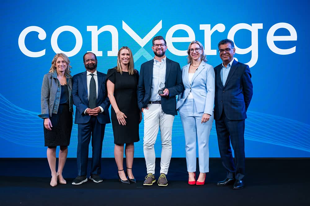 Group gathered at Converge for client award ceremony photo