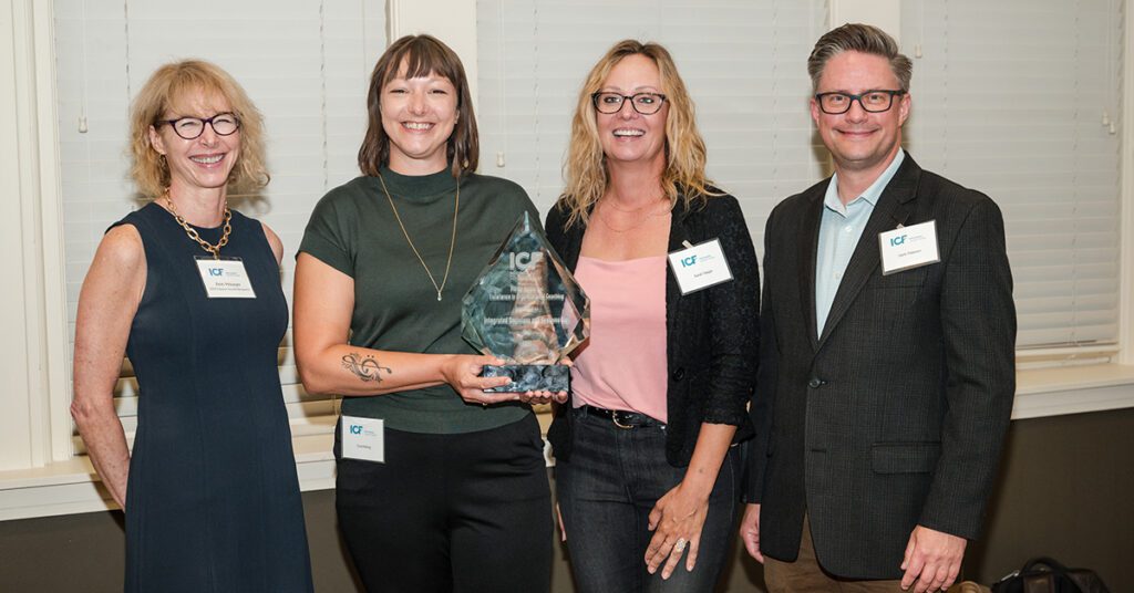 Group photo of IDeaS representatives receiving award.